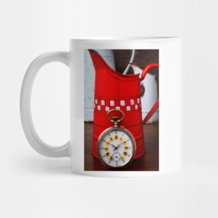 Beautiful Pocket Watch Against Red Pitcher Mug